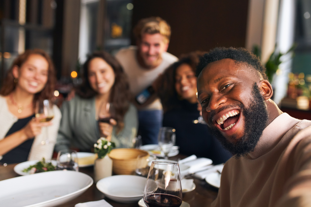 Diverse Friends Taking Group Selfie in a Restaurant